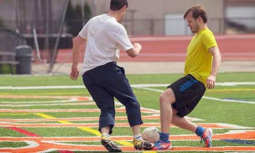 Students playing soccer at Schneider Stadium